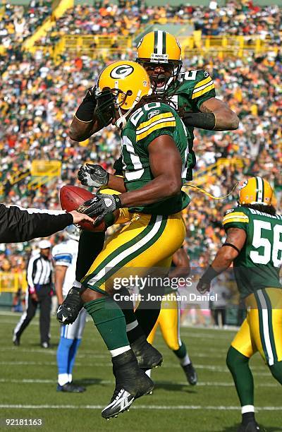 Charles Woodson of the Green Bay Packers celebrates an interception in the end zone by teammate Atari Bigby against the Detroit Lions at Lambeau...