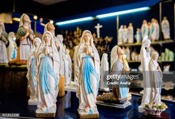 Lourdes . Souvenir shop, statuettes of the Virgin Mary and St Bernadette Soubirous on sale.