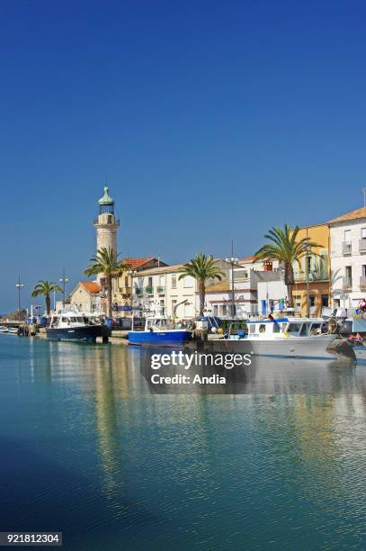Le Grau-du-Roi : fishing boats alongside the quay 'quai General de Gaulle'. In the background, the Old Lighthouse registered as a National Historic...