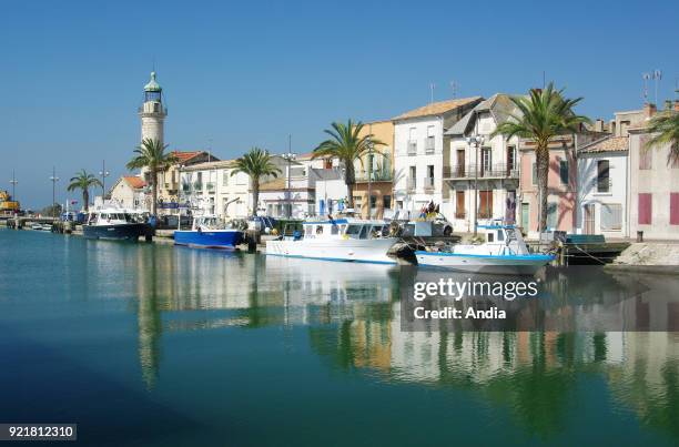 Le Grau-du-Roi : fishing boats alongside the quay 'quai General de Gaulle'. In the background, the Old Lighthouse registered as a National Historic...