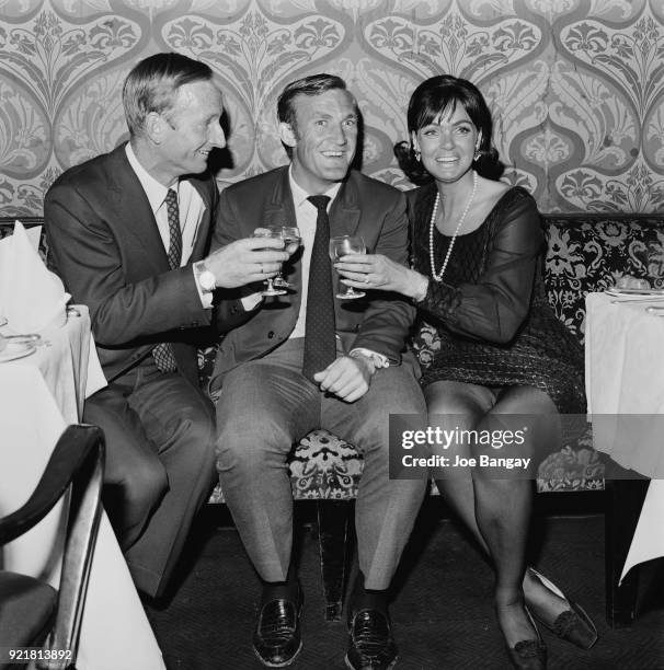 Tennis players Rod Laver, Tony Roche and Laver's wife Mary Benson celebrate after Wimbledon Championships, London, UK, 5th July 1968.