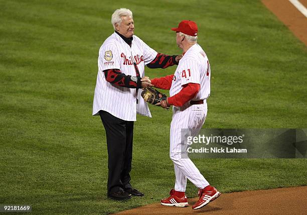 Dallas Greene shakes hands with manager Charlie Manuel of the Philadelphia Phillies before taking on the Los Angeles Dodgers in Game Five of the NLCS...