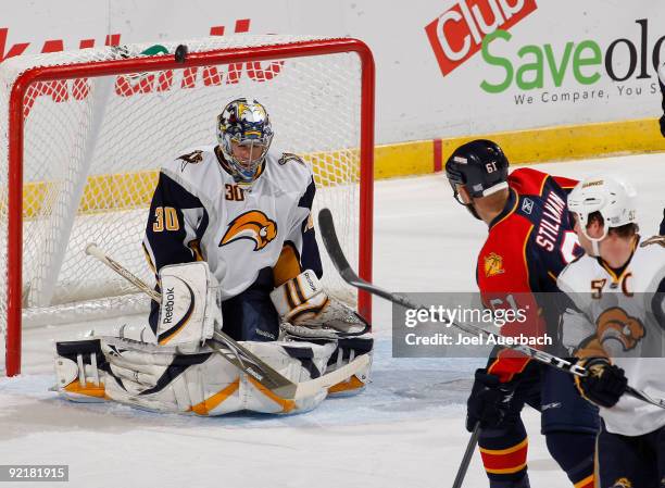 Goaltender Ryan Miller of the Buffalo Sabres deflects the puck over the crossbar on a shot taken by Cory Stillman of the Florid Panthers in the first...