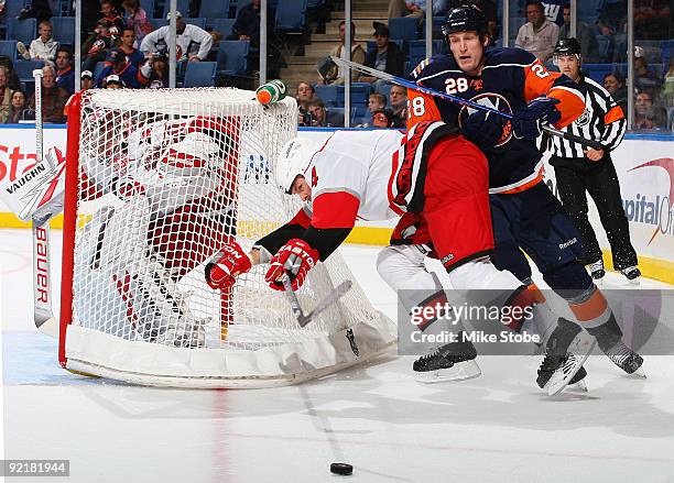 Tim Jackman of the New York Islanders tries to get past Aaron Ward of the Carolina Hurricanes on October 21, 2009 at Nassau Coliseum in Uniondale,...