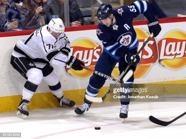Torrey Mitchell of the Los Angeles Kings and Mark Scheifele of the Winnipeg Jets battle for the loose puck during second period action at the Bell...
