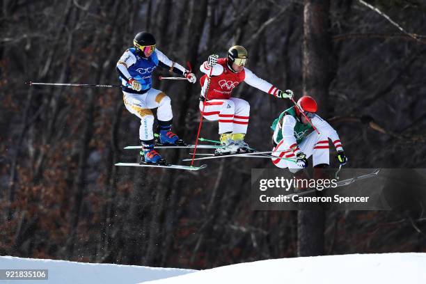 Christoph Wahrestoetter of Austria, Erik Mobaerg of Sweden and Robert Winkler compete in the Freestyle Skiing Men's Ski Cross 1/8 finals on day 12 of...