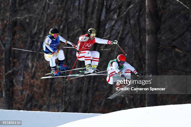 Christoph Wahrestoetter of Austria, Erik Mobaerg of Sweden and Robert Winkler compete in the Freestyle Skiing Men's Ski Cross 1/8 finals on day 12 of...
