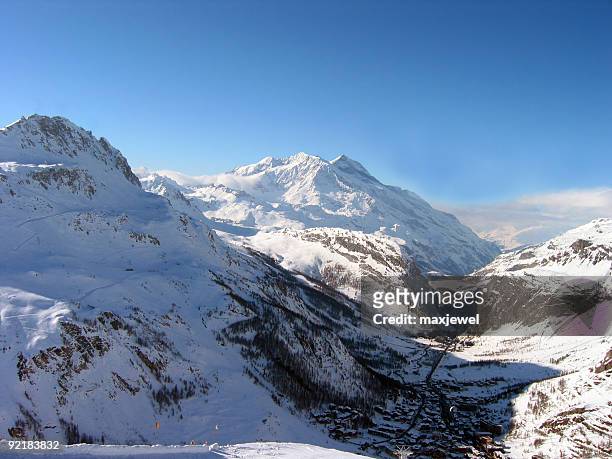 shadow of the alps over val d'isere france - val d'isere stock pictures, royalty-free photos & images