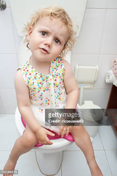 baby girl sitting on the toilet - girls peeing stock pictures, royalty-free photos & images