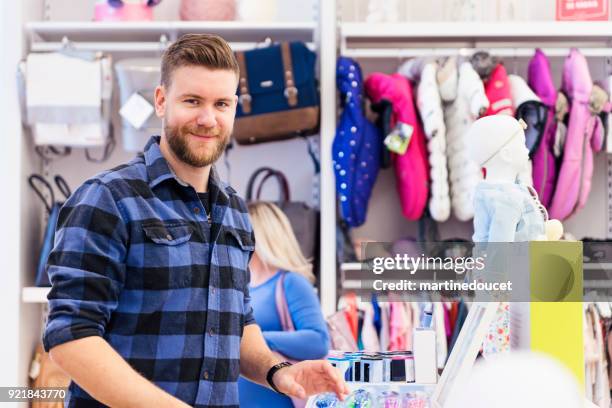 man shopping in a children store. - one man only stock pictures, royalty-free photos & images