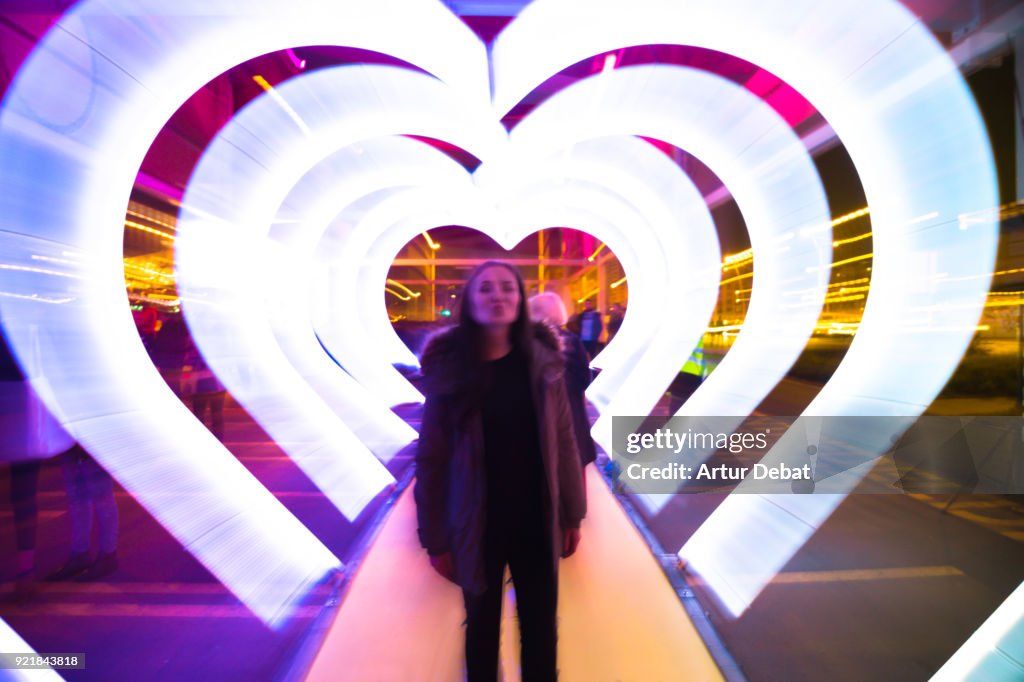 Creative picture with zoom technique of illuminated hearts creating tunnel effect with light trails.