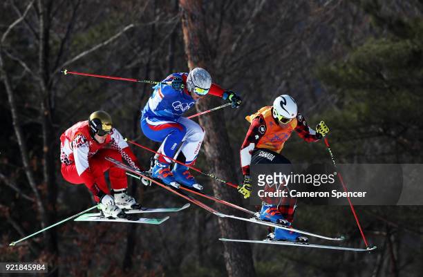 Siegmar Klotz of Italy, Sergey Ridzik of Olympic athletes of Russia and Francois Place of France compete in the Freestyle Skiing Men's Ski Cross 1/8...