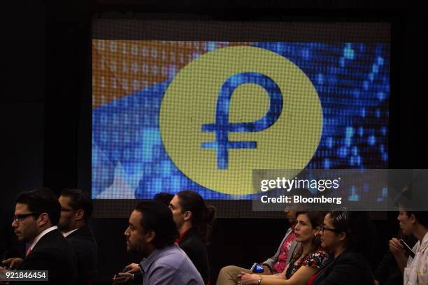 People attend the Petro cryptocurrency launch event in Caracas, Venezuela, on Tuesday, Feb. 20, 2018. Maduro launched Petro to use as a new...