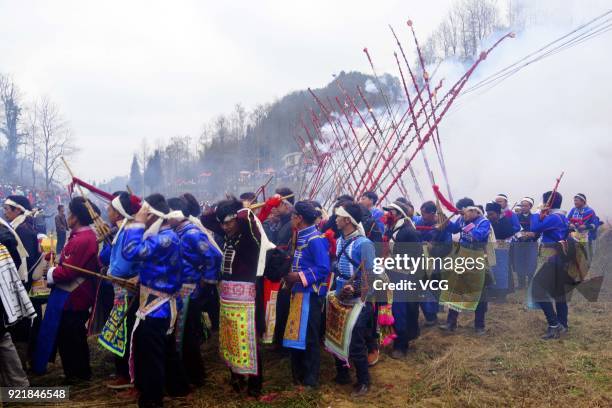 Miao people set off firecrackers during the worshipping ceremony of ancestors on the fifth day of the Lunar New Year on February 20, 2018 in Guiyang,...