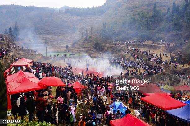 Miao people set off firecrackers during the worshipping ceremony of ancestors on the fifth day of the Lunar New Year on February 20, 2018 in Guiyang,...