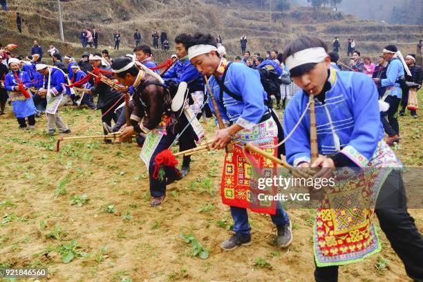 Miao people play Lusheng during the worshipping ceremony of ancestors on the fifth day of the Lunar New Year on February 20, 2018 in Guiyang, Guizhou...