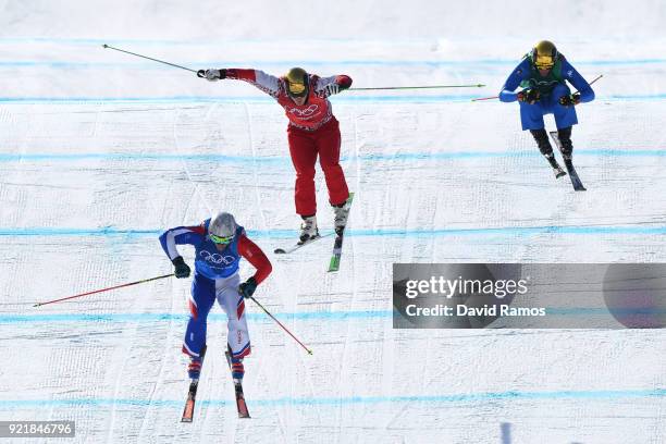 Sergey Ridzik of Olympic athletes of Russia, Francois Place of France, and Siegmar Klotz of Italy competes in the Freestyle Skiing Men's Ski Cross...