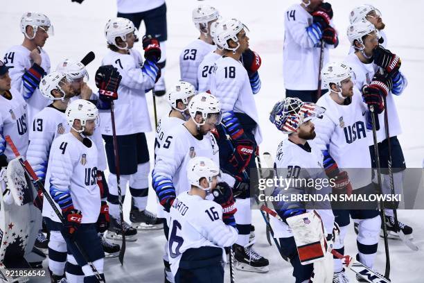 Team USA react after losing in overtime during the men's quarterfinals playoffs ice hockey match between Czech Republic the United States during the...