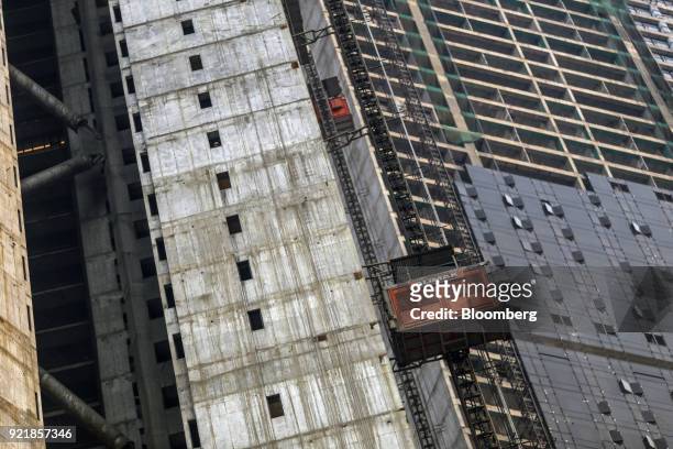 Construction elevators operate at one of the two towers of Trump Tower Mumbai under construction at Lodha The Park, a luxury residential project...