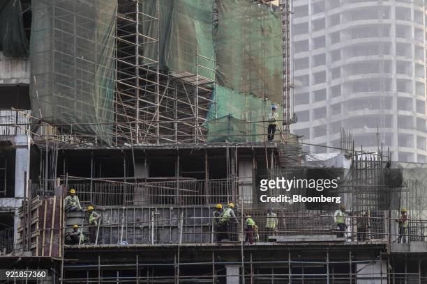 Workers labor at the construction site for Trump Tower Mumbai at Lodha The Park, a luxury residential project developed by Lodha Developers Ltd., in...
