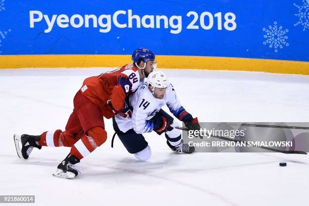 Czech Republic's Tomas Kundratek and USA's Broc Little fight for the puck during overtime in the men's quarterfinals playoffs ice hockey match...