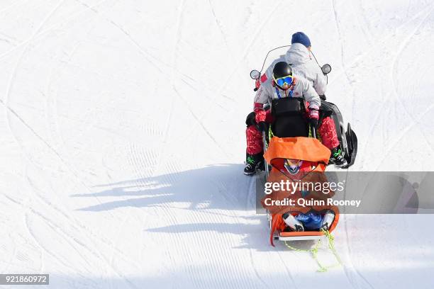 Christoph Wahrestoetter of Austria is taken off court after he crashes in the Freestyle Skiing Men's Ski Cross 1/8 finals on day 12 of the...