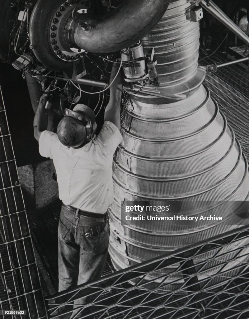 A technician fuelling a H-1 liquid propellant rocket engine.