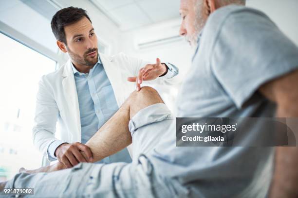 senior man having medical exam. - rheumatism stock pictures, royalty-free photos & images