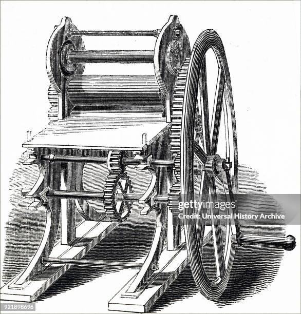Illustration depicting the process of bookbinding: bookbinder's rolling machine. Dated 19th century.