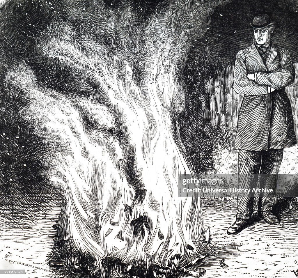 A man burning books on a bonfire.