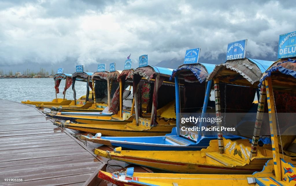 Empty Shikaras tied to a wooden pier at world famous Dal...