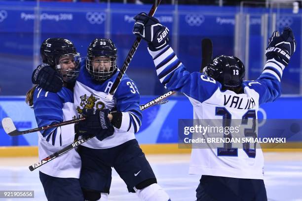 Finland's Susanna Tapani , Finland's Michelle Karvinen , and Finland's Riikka Valila celebrate a goal in the women's bronze medal ice hockey match...