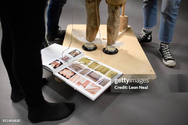 Historical reference book lays open as members of the conservation team fit a 'pair of straight bodies' to the funeral effigy of Elizabeth I at...