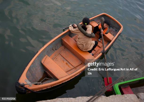 North Korean people in rowing boat on Taedong river, Pyongan Province, Pyongyang, North Korea on April 13, 2008 in Pyongyang, North Korea.