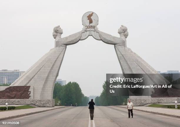 Tourists taking pictures at the reunification monument on the highway, Pyongan Province, Pyongyang, North Korea on April 21, 2008 in Pyongyang, North...