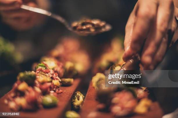 chef at work. caterer cooking in commercial kitchen - tapas stock pictures, royalty-free photos & images