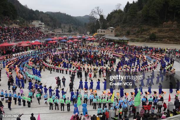 Miao people dance to the rhythm of music to worship ancestors and pray for good weather on the fifth day of the Lunar New Year on February 20, 2018...