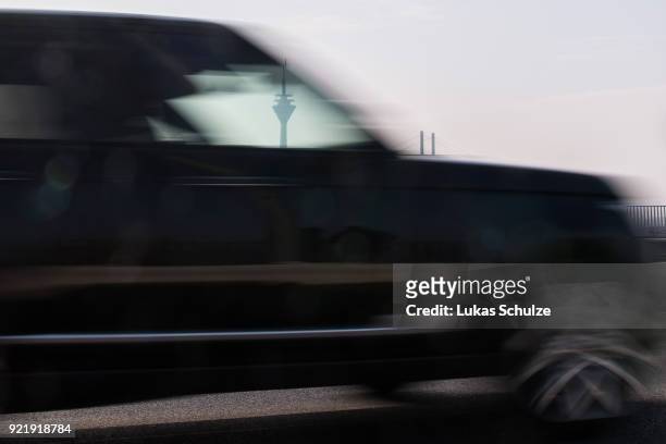 Car drives along the Rhine River as the Rheinturm telecommunications towers stands behind on February 20, 2018 in Dusseldorf, Germany. The German...