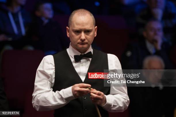 Graeme Dott of Scotland chalks the cue during his first round match against Joe Perry of England on day two of 2018 Ladbrokes World Grand Prix at...