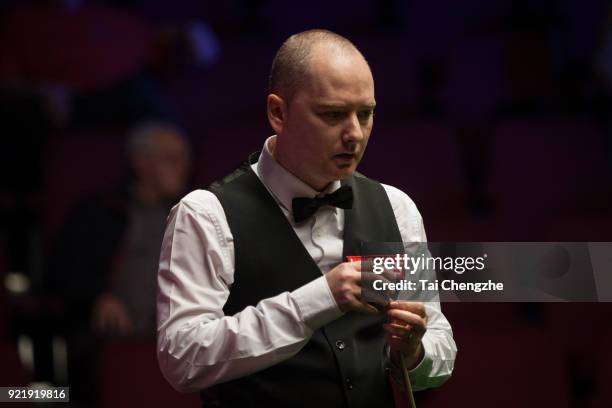 Graeme Dott of Scotland chalks the cue during his first round match against Joe Perry of England on day two of 2018 Ladbrokes World Grand Prix at...