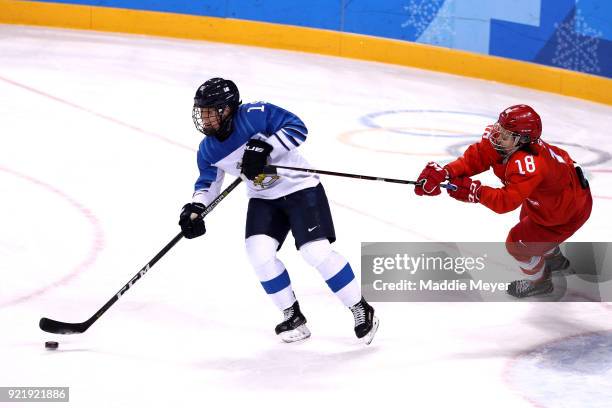 Minnamari Tuominen of Finland controls the puck against Olga Sosina of Olympic Athlete from Russia in the first period during the Women's Ice Hockey...