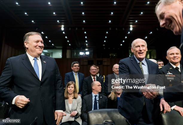 Director Mike Pompeo and Director of National Intelligence Dan Coats is greeted by ranking chairman Senator John Warner during a Senate Intelligence...
