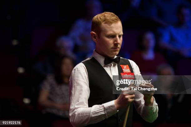 Anthony McGill of Scotland chalks the cue during his first round match against Cao Yupeng of China on day two of 2018 Ladbrokes World Grand Prix at...