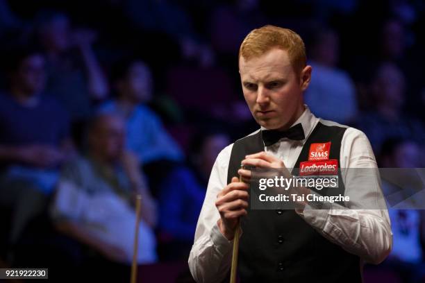 Anthony McGill of Scotland chalks the cue during his first round match against Cao Yupeng of China on day two of 2018 Ladbrokes World Grand Prix at...