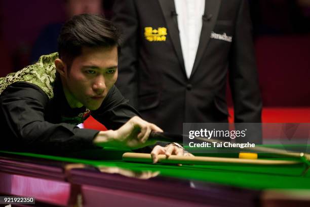 Cao Yupeng of China plays a shot during his first round match against Anthony McGill of Scotland on day two of 2018 Ladbrokes World Grand Prix at...