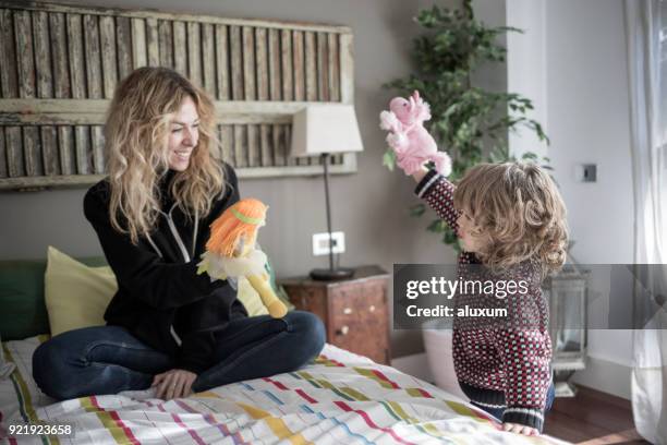 mother playing with puppets with her son at home - puppeteer stock pictures, royalty-free photos & images