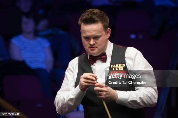 Shaun Murphy of England chalks the cue during his first round match against Ricky Walden of England on day two of 2018 Ladbrokes World Grand Prix at...