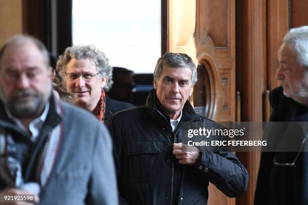 French former budget minister Jerome Cahuzac and his lawyers Eric Dupond-Moretti and Jean-Alain Michel leave Paris' courthouse on February 21, 2018...