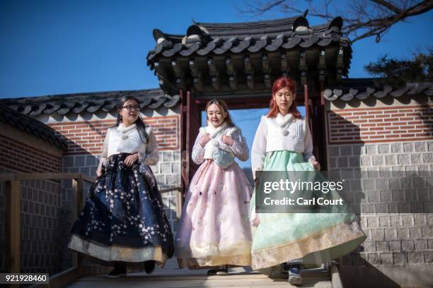 Tourists wearing traditional Korean Hanbok dresses visit Gyeongbokgung Palace on February 21, 2018 in Seoul, South Korea. With tourists visiting from...