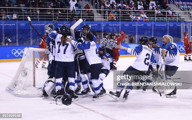 Finland's players celebrate winning the women's bronze medal ice hockey match between Finland and the Olympic Athletes from Russia during the...